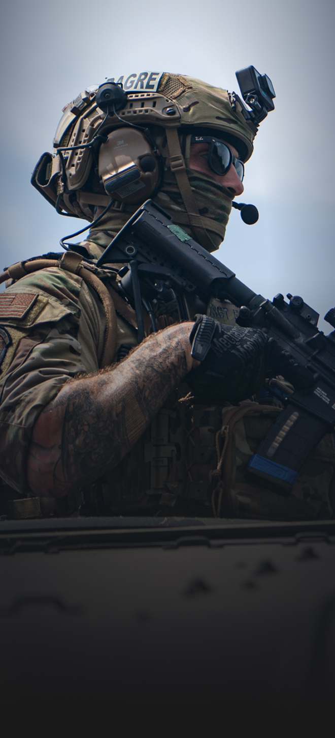 airman holding rifle with dagre patch on helmet
