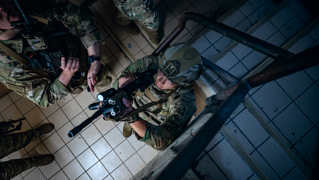 airman looking up and pointing a rifle upward