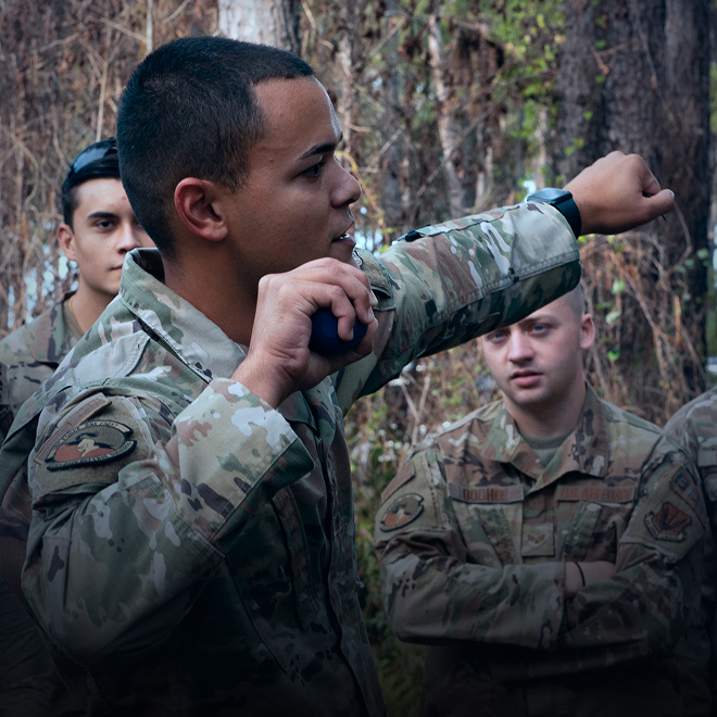 airman demonstrating proper hand grenade handling