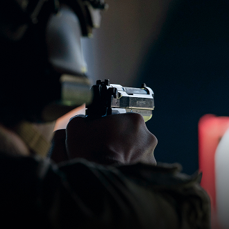 close up of airman's hands holding pistol