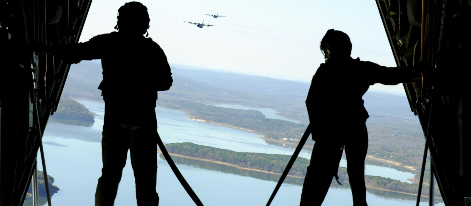Air National Guardsman standing at the back hatch of an airplane in flight