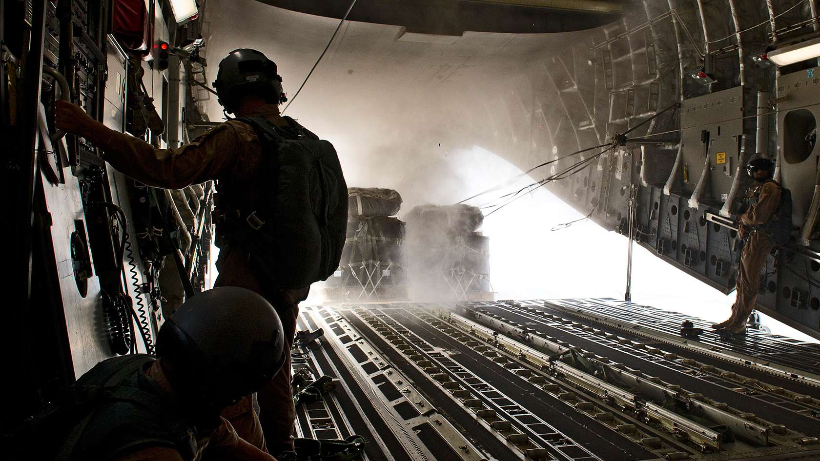 airman loading materials on to a plane