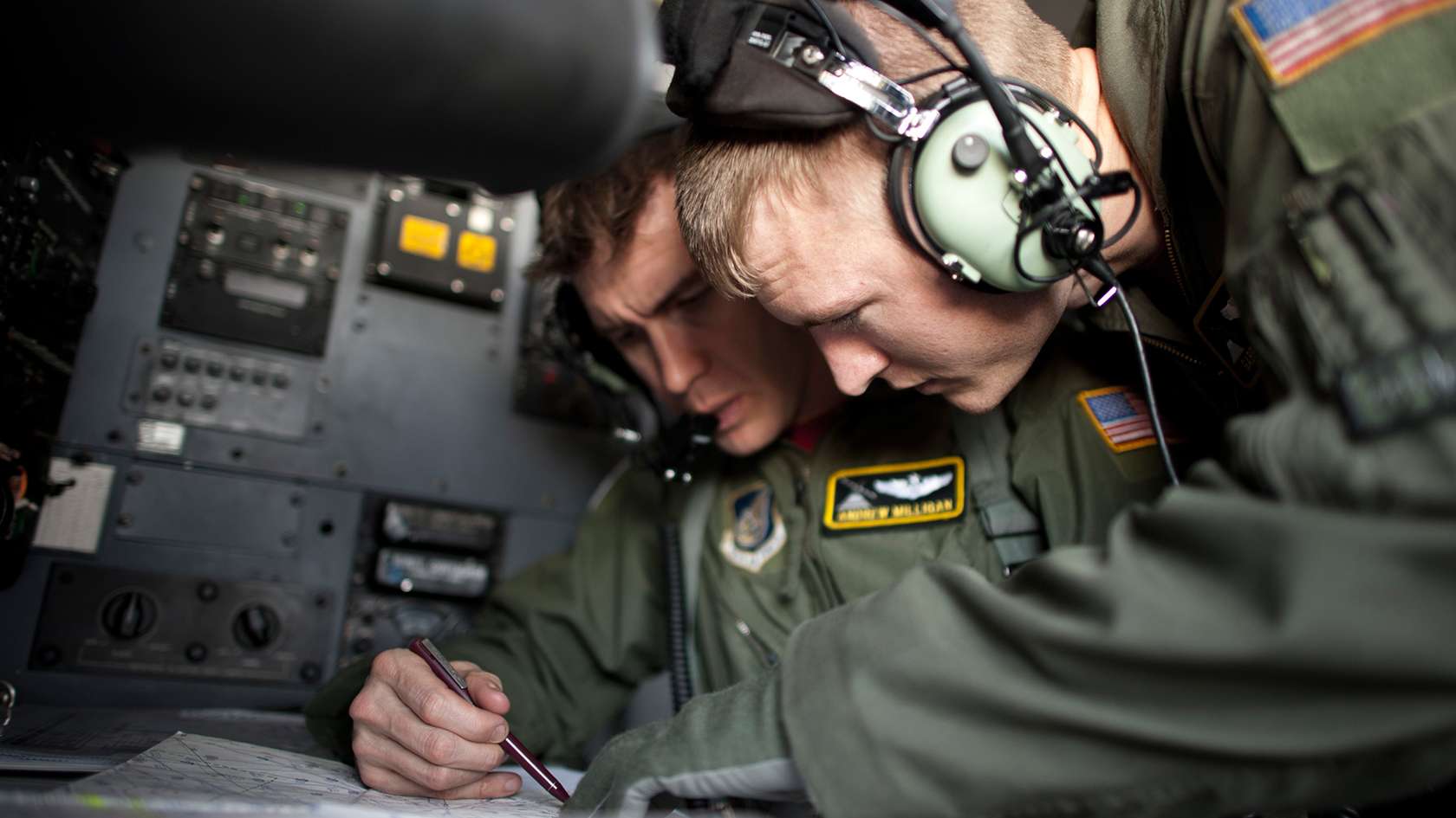 Two Combat Systems Officers in discussion
