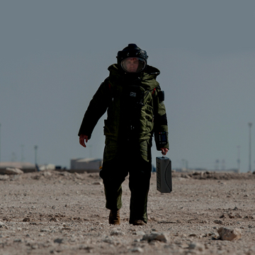 Explosive Ordnance Disposal specialist walking with equipment