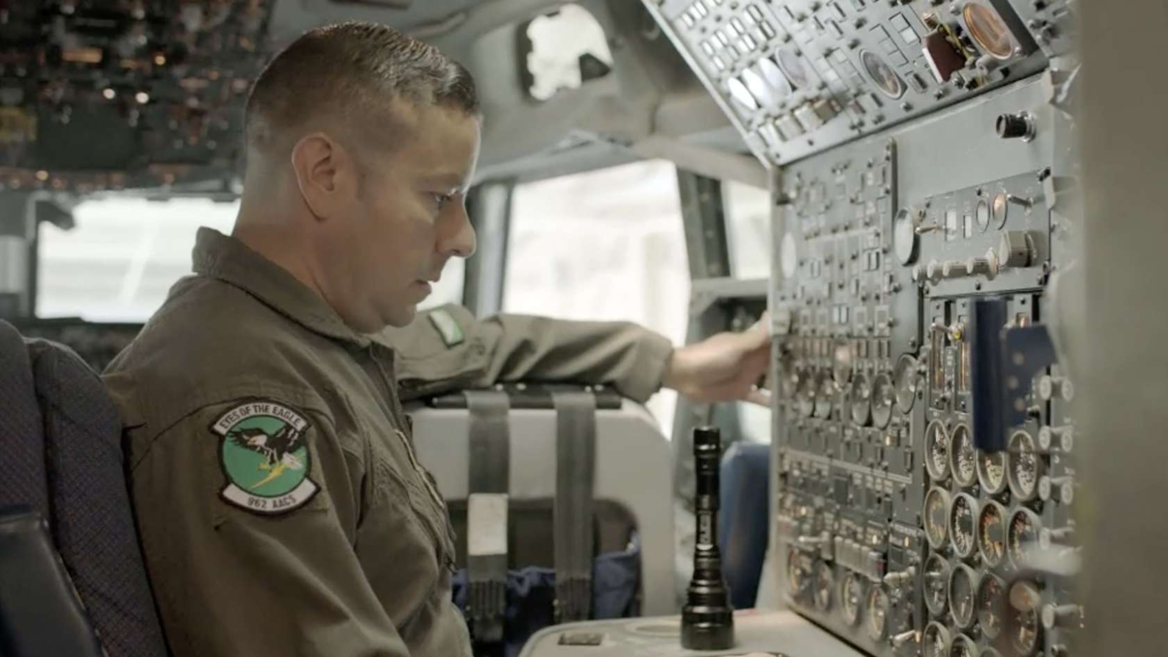 airman looking at a control board