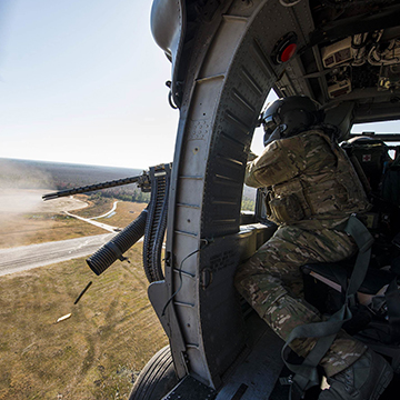 Special Missions Aviator firing artillery from helicopter