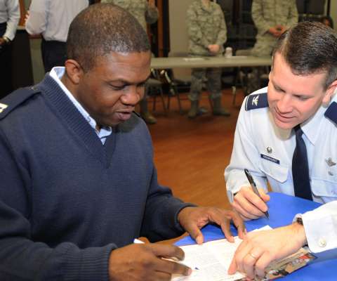 FORCE SUPPORT officer speaking to an airman