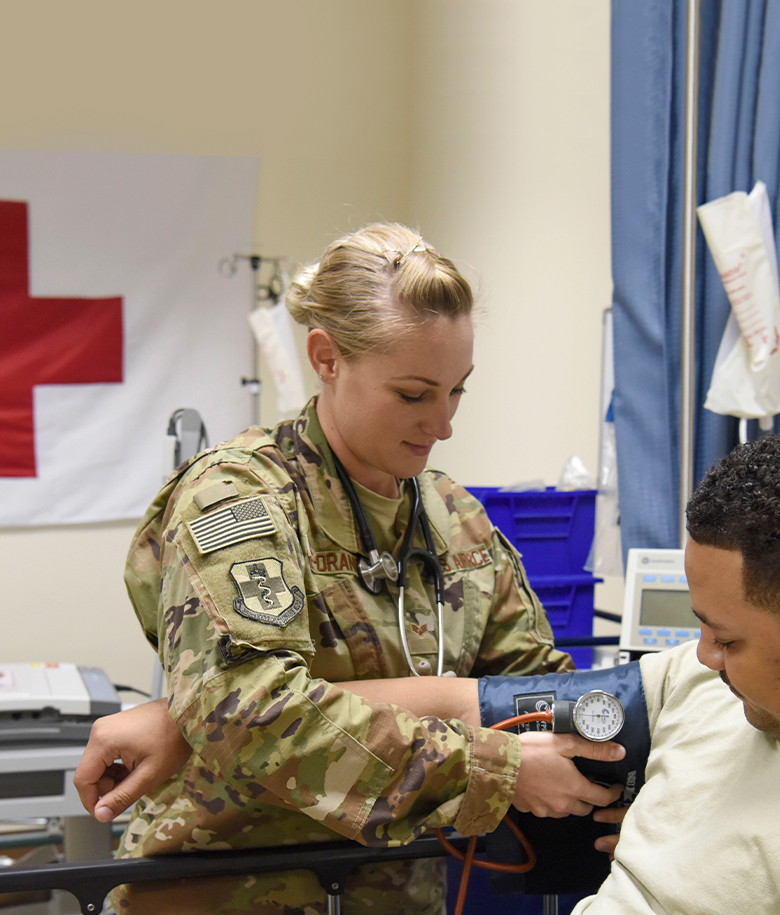 aerospace medical service checking patient's blood pressure