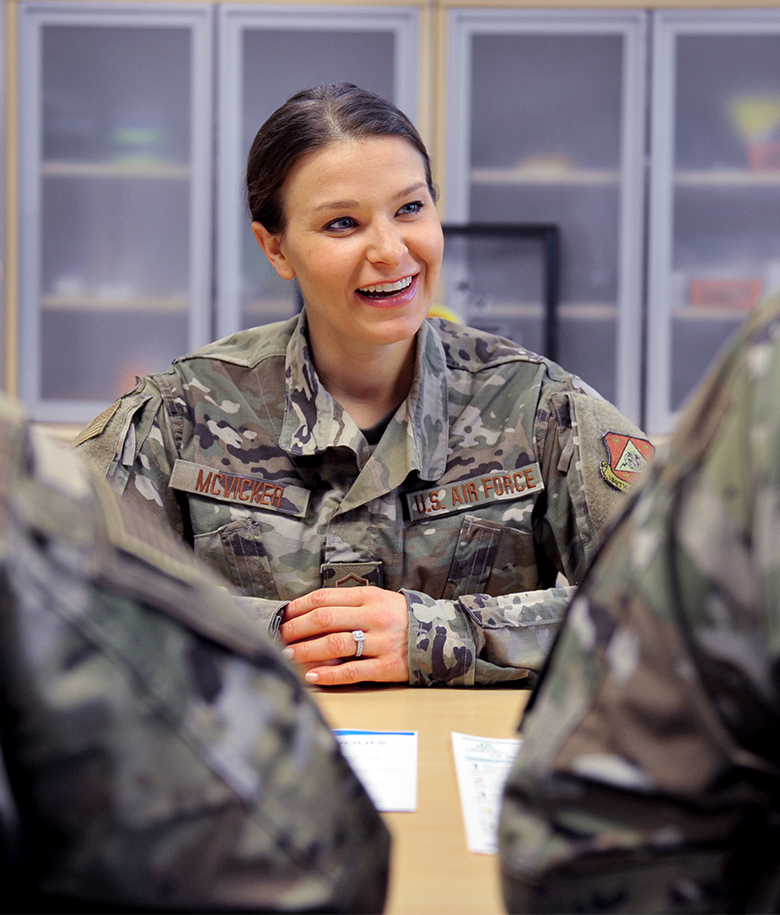 dietitian smiling and talking to two other airmen