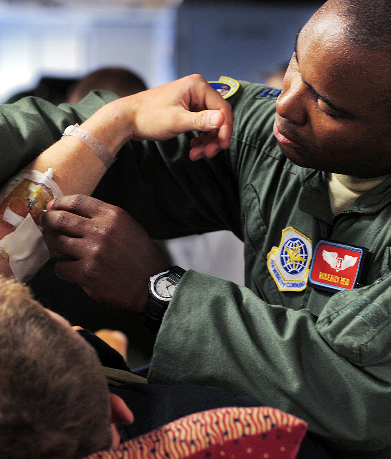 Air Force flight nurse inserting IV