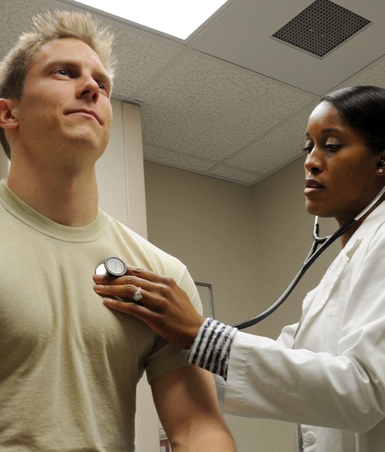 Physician Assistant listening to an airman's heartbeat