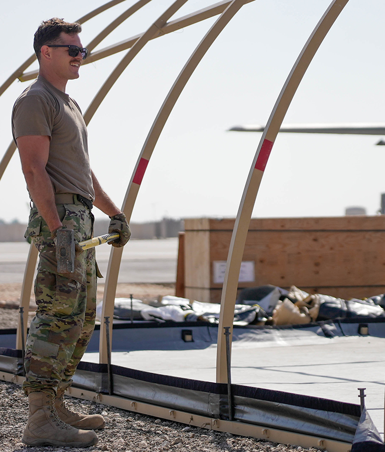 airman standing in front of a structure 