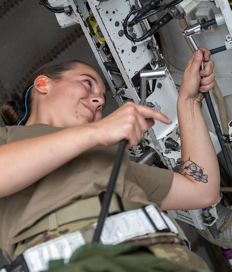 airman working performing maintenance on an equipment