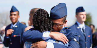 airman hugging family member